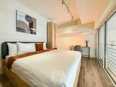 a bedroom with a large bed and a desk at Sleek 1BR Loft in Luxury High-Rise - 103 - GL in Glendale