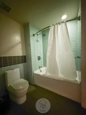 a bathroom with a toilet and a tub and a shower at Modern 2BR Loft with Luxury Amenities - 109 - GL in Glendale