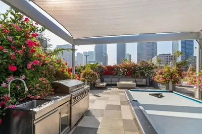 an outdoor kitchen with flowers on a rooftop at Modern 2BR Loft with Luxury Amenities - 109 - GL in Glendale