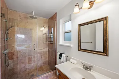 a bathroom with a shower and a sink and a mirror at Mountain View Luxury Estate with Pool in West Hills in Chatsworth Lake Manor