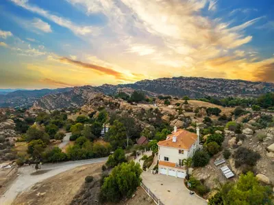 an aerial view of a house on a hill at Mountain View Luxury Estate with Pool in West Hills in Chatsworth Lake Manor