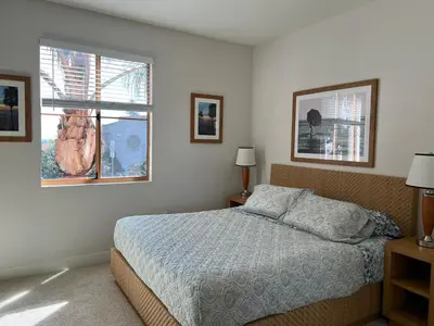 a bedroom with a bed and two windows at Chic Residences Steps from Beverly Hills & Sony Pictures in Los Angeles