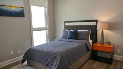 a bedroom with a bed and a window at Chic Residences Steps from Beverly Hills & Sony Pictures in Los Angeles