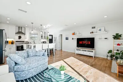 a living room with a couch and a kitchen at Charming Modern Escape with Outdoor Living in San Dimas