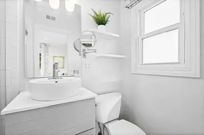 a white bathroom with a sink and a toilet at Charming Modern Escape with Outdoor Living in San Dimas