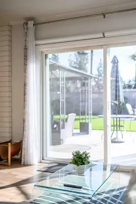 a glass table with a potted plant on it in front of a window at Charming Modern Escape with Outdoor Living in San Dimas