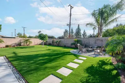 a backyard with a lawn with a table and chairs at Charming Modern Escape with Outdoor Living in San Dimas