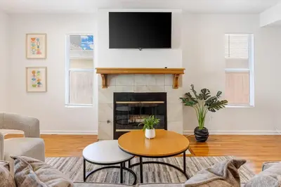 a living room with a table and a fireplace at Spacious Culver City 4BR - Half Block from Amazon in Los Angeles