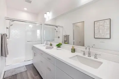a white bathroom with two sinks and a shower at Modern Townhouse Near Disneyland & OC Beaches in Covina