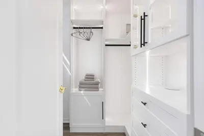 a white bathroom with white cabinets and a sink at Modern Townhouse Near Disneyland & OC Beaches in Covina