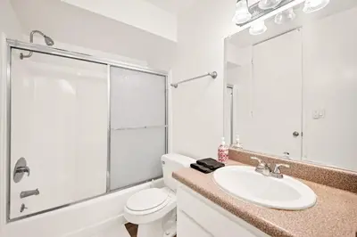 a white bathroom with a sink and a toilet at Lux Marina Village with parking in Los Angeles