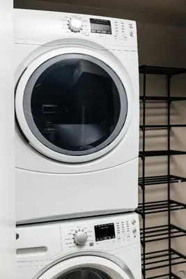 two white washing machines stacked on top of each other at Elegant 2BD WeHo Apartment in Los Angeles