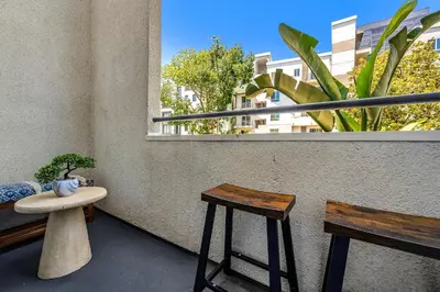 a balcony with two stools and a window at Heart of La, Walk to everything!! in Los Angeles