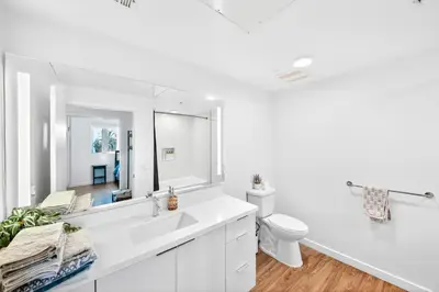 a white bathroom with a sink and a toilet at fusion hollywood in Los Angeles