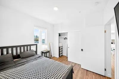 a bedroom with a black and white bed and a window at fusion hollywood in Los Angeles