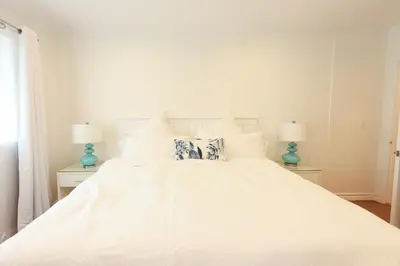 a bedroom with a white bed with two lamps at SM ocean view in Los Angeles