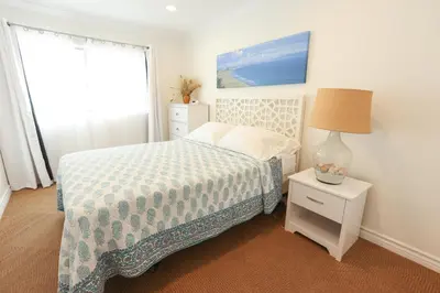 a bedroom with a bed and a lamp and a window at SM ocean view in Los Angeles