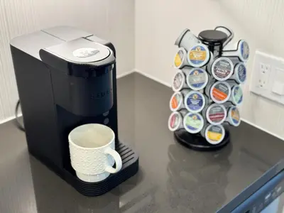 a coffee maker with a cup on a counter at New Oasis Near Disneyland Pool Gym Free Parking in Santa Ana