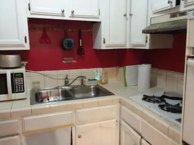 a small kitchen with a sink and a microwave at Affordable Rooms in RV Trailer in Los Angeles