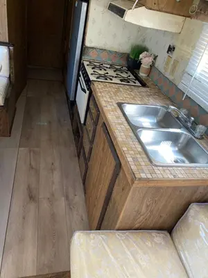 a kitchen with a sink and a stove at Affordable Rooms in RV Trailer in Los Angeles