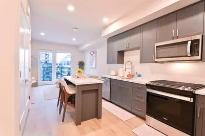 a kitchen with gray cabinets and a white counter top at Elevated Escape Luxury 1BR in Hollywood in Los Angeles
