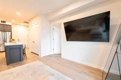 a living room with a large flat screen tv on a wall at Elevated Escape Luxury 1BR in Hollywood in Los Angeles