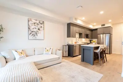 a living room with a couch and a kitchen at Elevated Escape Luxury 1BR in Hollywood in Los Angeles