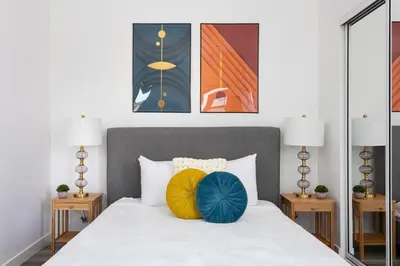 a bedroom with a white bed with two lamps at Upscale LA Getaway Sleeps 8 with Free Parking in Los Angeles