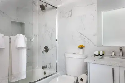 a bathroom with a shower and a toilet and a sink at Upscale LA Getaway Sleeps 8 with Free Parking in Los Angeles