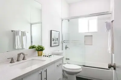 a white bathroom with a toilet and a shower at Central 4BR Townhome Modern Perks in Los Angeles