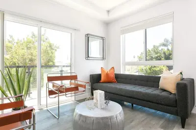 a living room with a couch and a table at Spacious 4BR LA Getaway with Parking and Fast Wi-Fi in Los Angeles