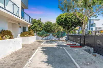 a driveway in front of a house with a fence at Spacious 5BR Townhouse with Free Parking Included in Los Angeles