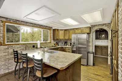 a kitchen with a counter top and a refrigerator at Arlberg Village Haus Game Room Walk to the Slopes in Big Bear Lake