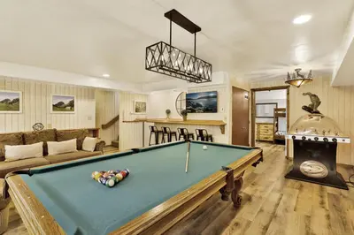 a living room with a pool table and a couch at Arlberg Village Haus Game Room Walk to the Slopes in Big Bear Lake