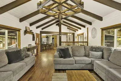 a living room with a large couch and a table at Arlberg Village Haus Game Room Walk to the Slopes in Big Bear Lake