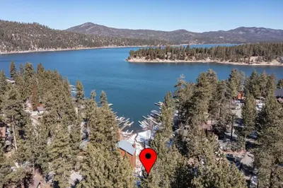a red spot on top of a lake with trees at Cove Lakeside Jacuzzi, Central AC, Stunning View in Big Bear Lake