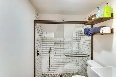 a bathroom with a shower and a toilet at Golf and Swim! Pine Mtn Club Retreat with Game Area in Pine Mountain Club
