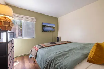 a bedroom with a large bed and a window at Dream Lake Cabin Spa, EV Charger, Gated, by lake! in Big Bear Lake