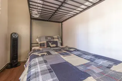 a bedroom with a bed with a quilt on it at Dream Lake Cabin Spa, EV Charger, Gated, by lake! in Big Bear Lake
