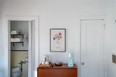 a bathroom with a table with a picture on the wall at Modern Bachelor in Hollywood in Los Angeles