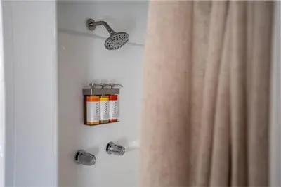 a shower with a shower curtain next to a shower at Modern Bachelor in Hollywood in Los Angeles