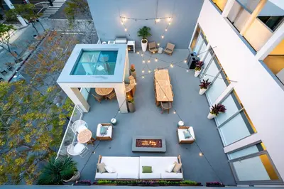 an overhead view of a building with a pool and furniture at WEHO Place By Sunset Plaza in Los Angeles