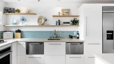 a kitchen with white cabinets and a sink at Walk to Manhattan Beach Pier Ocean Views Balcony Peloton Casa Del Mar by AvantStay in Manhattan Beach