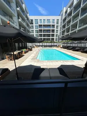 a swimming pool in front of a large building at Luxury 2BR Apt with balcony!! in Los Angeles