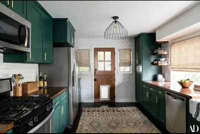 a green kitchen with green cabinets and a stove at The Whitley Heights Sweet Escape With Jacuzzi and parking in Los Angeles