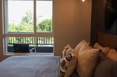 a bedroom with a bed and a large window at Bright & Cozy Getaway with Pool Free Parking 10 mins Disneyland in Santa Ana