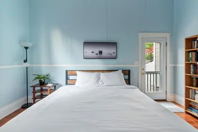 a bedroom with a large bed with a blue wall at Sea View, Sauna, Hot Tub, Beach Bikes, Stream in Ventura
