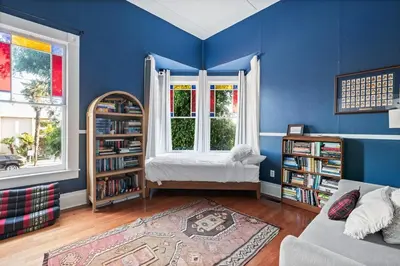a living room with blue walls and a window and a couch at Sea View, Sauna, Hot Tub, Beach Bikes, Stream in Ventura