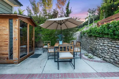 a patio with a table and an umbrella at Ocean View, Hot Tub, Sauna, Beach Bikes in Ventura