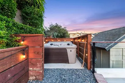 a backyard with a stove and a fence with lights at Ocean View, Hot Tub, Sauna, Beach Bikes in Ventura